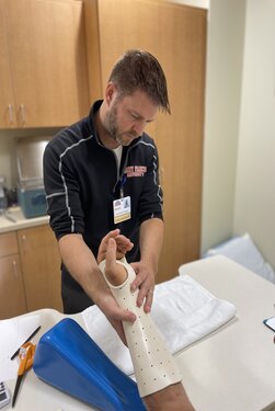 Male therapists working on a patients hand